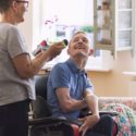 Direct Funding: Young man with cerebral palsy in wheelchair laughing