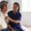 Ethnic nursing homes: woman listening to man's heart